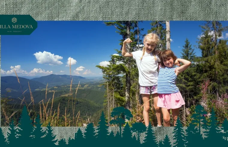 Vidpochynok z ditmy v Karpatakh kudy poyikhaty i chym zaynyaty malechu Two girls pose proudly with flexed arms on a mountain overlook, with trees and a blue sky behind; Villa Medova logo in the top-left corner.